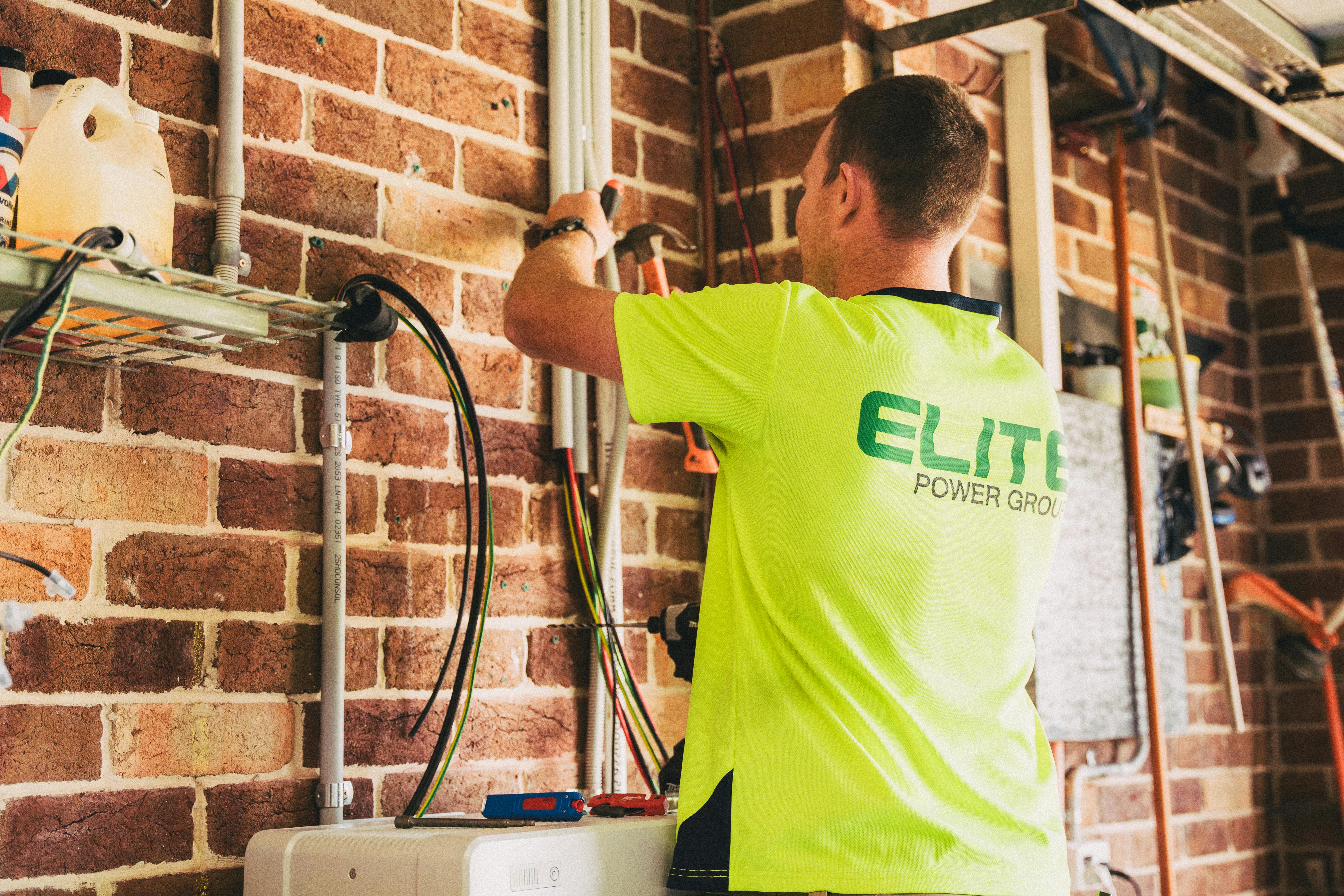 Electrician working on a switchboard in Auckland